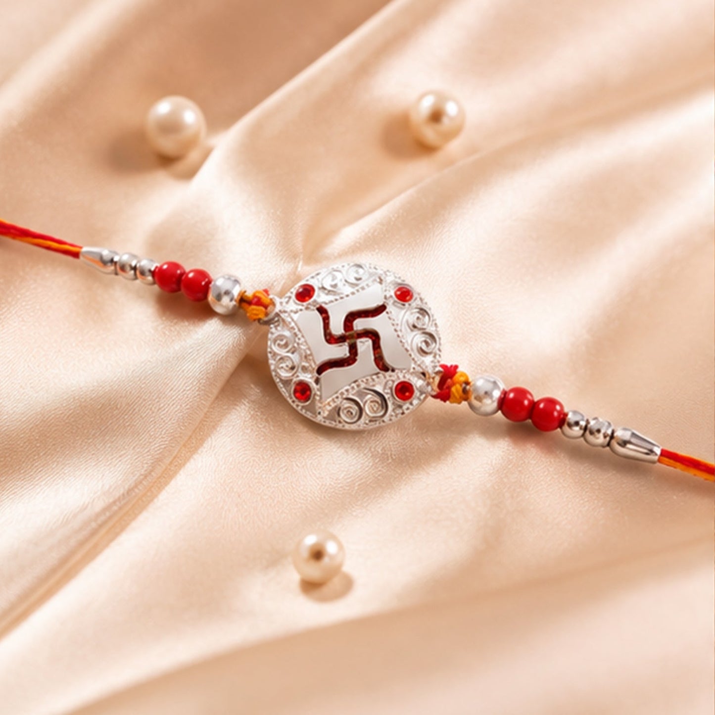 Close-up of silver swastik stone centerpiece on rakhi