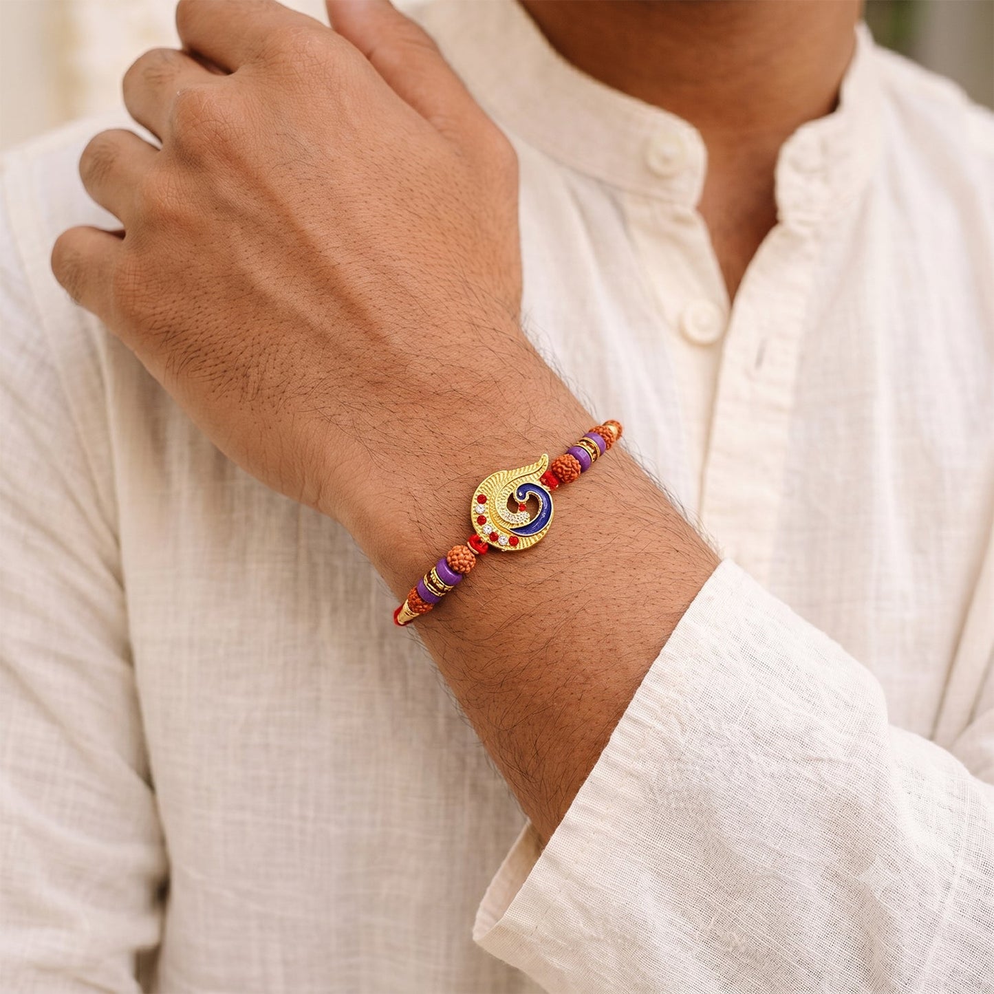 Lightweight Rakhi worn on wrist, highlighting its elegant design.