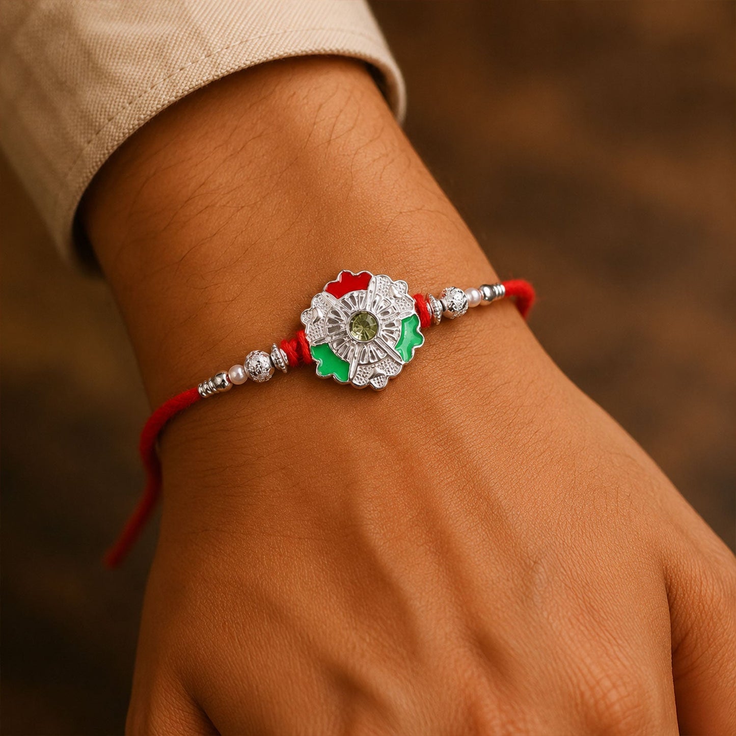 Side view of green white flower rakhi with silver beads