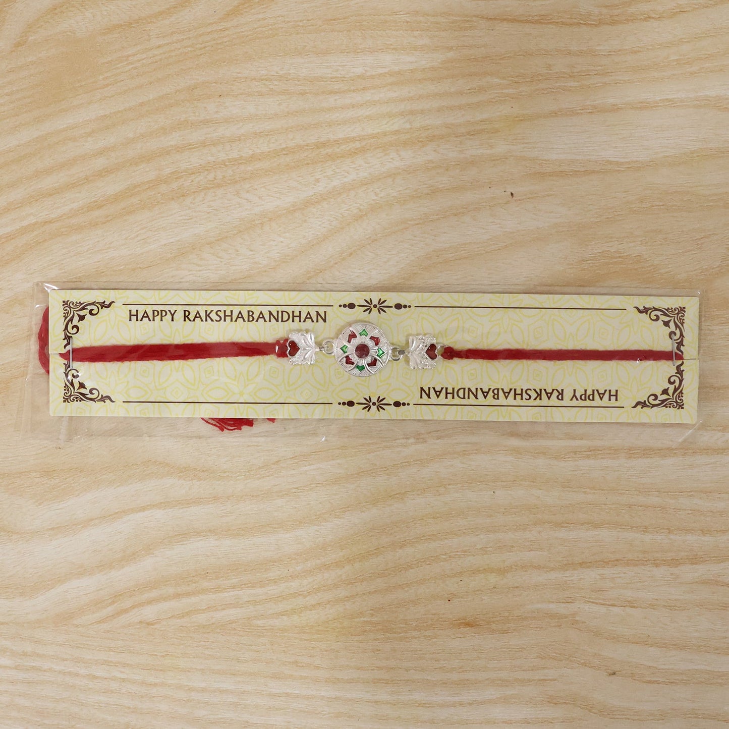 Festive silver rakhi featuring intricate bead details and lightweight thread