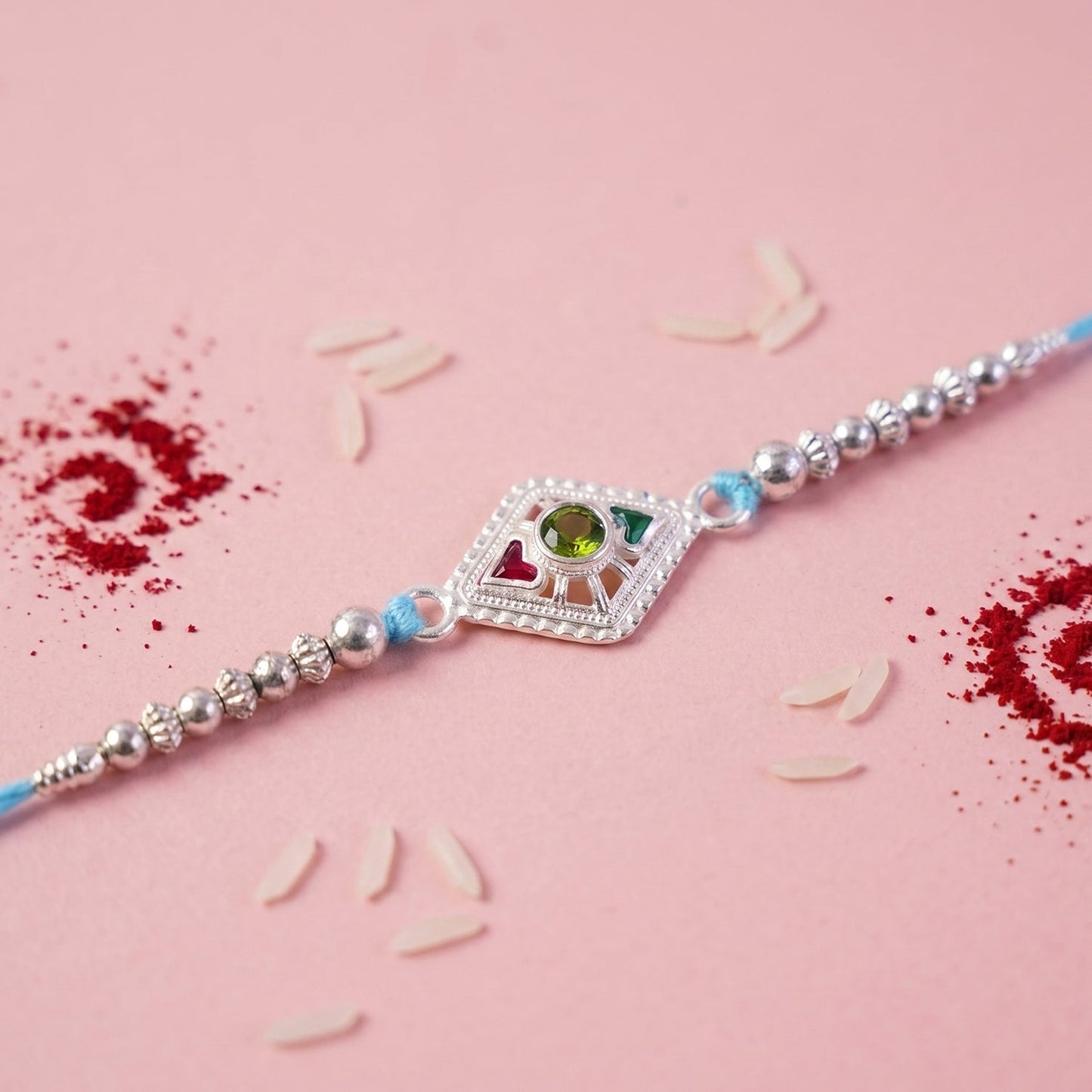 Side angle of Silver Diamond Kundan Rakhi showing decorative beads