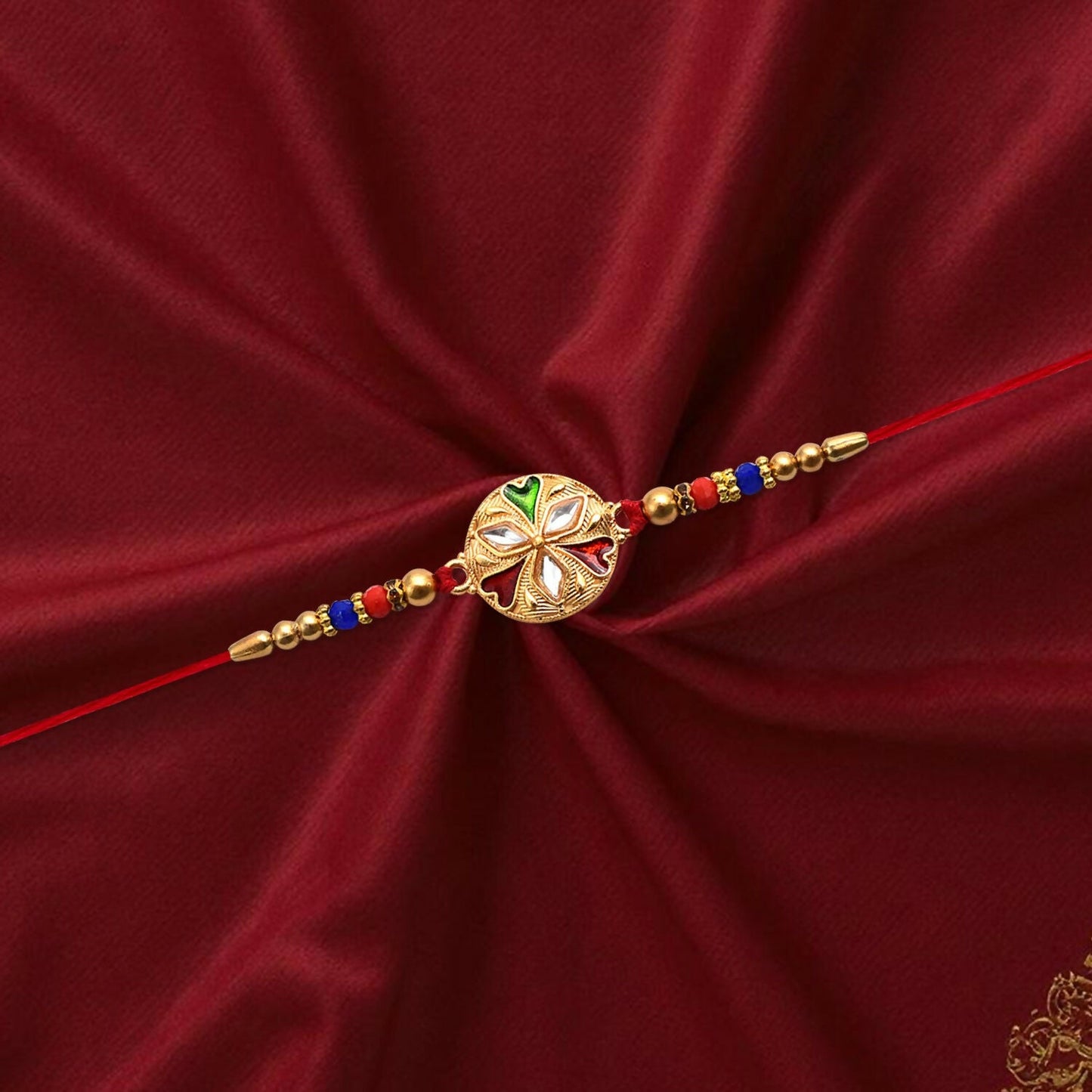 Exclusive golden Rakhi tied with a red thread for Raksha Bandhan festivities