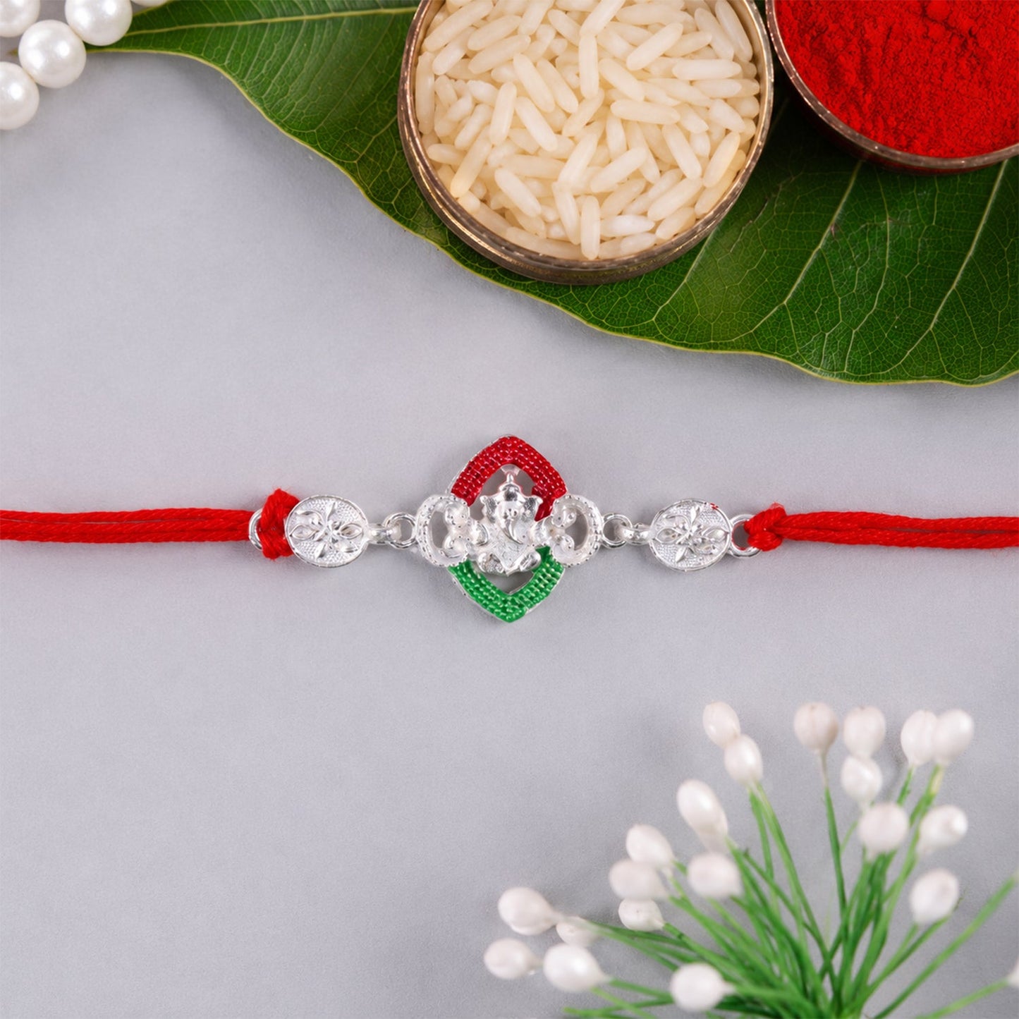 Close-up of the floral design on the Silver Green Floral Rakhi