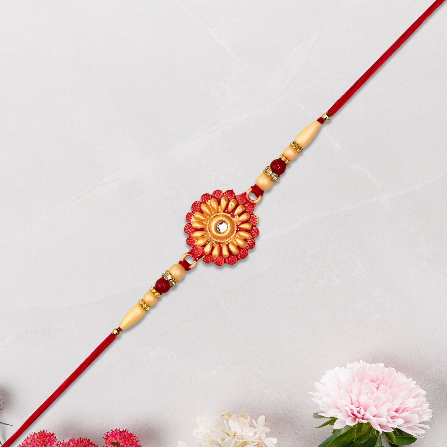 Detailed view of floral beads and central stone on Rakhi