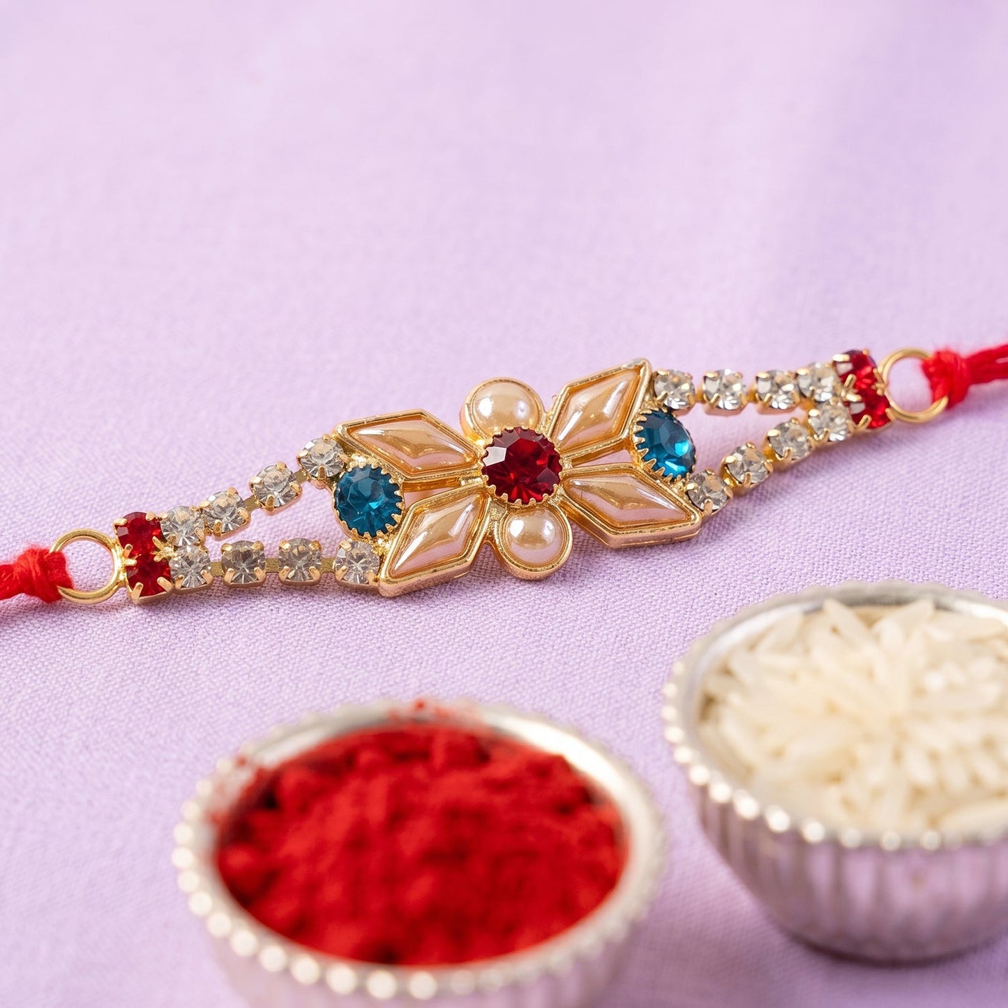 Pastel Floral Kundan Rakhi worn on wrist display