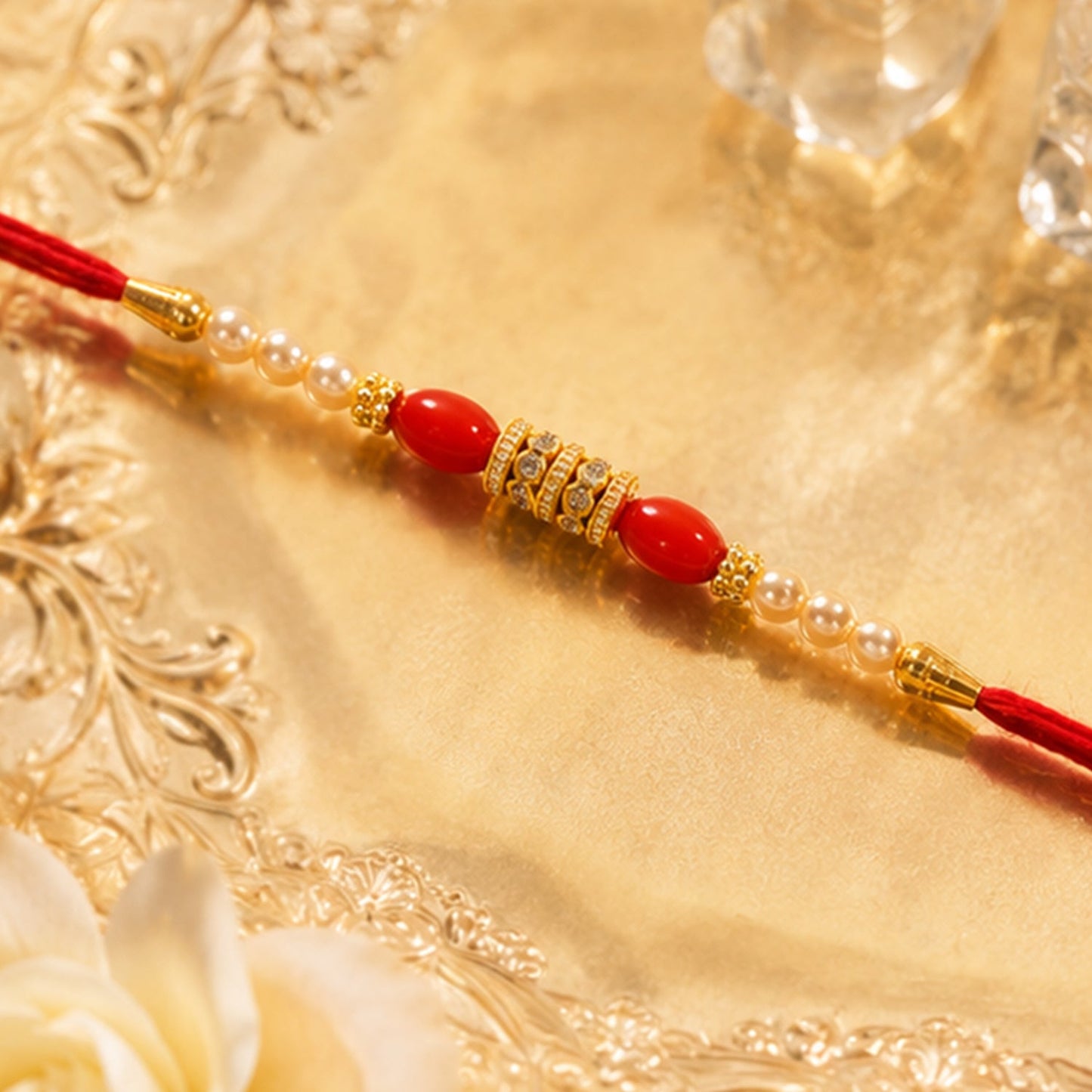 Decorative bead and gold spacer detailing on traditional rakhi design