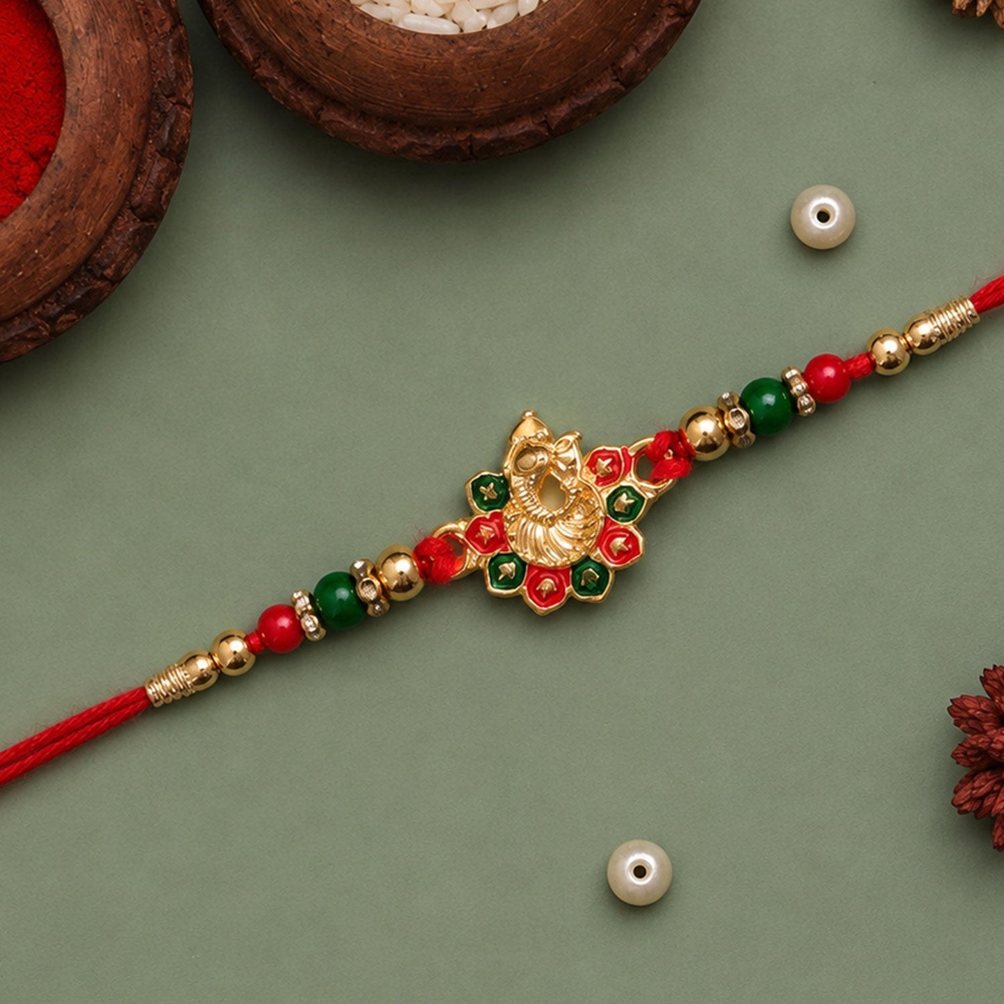Festive presentation of Ganesha Rakhi against an Indian traditional backdrop