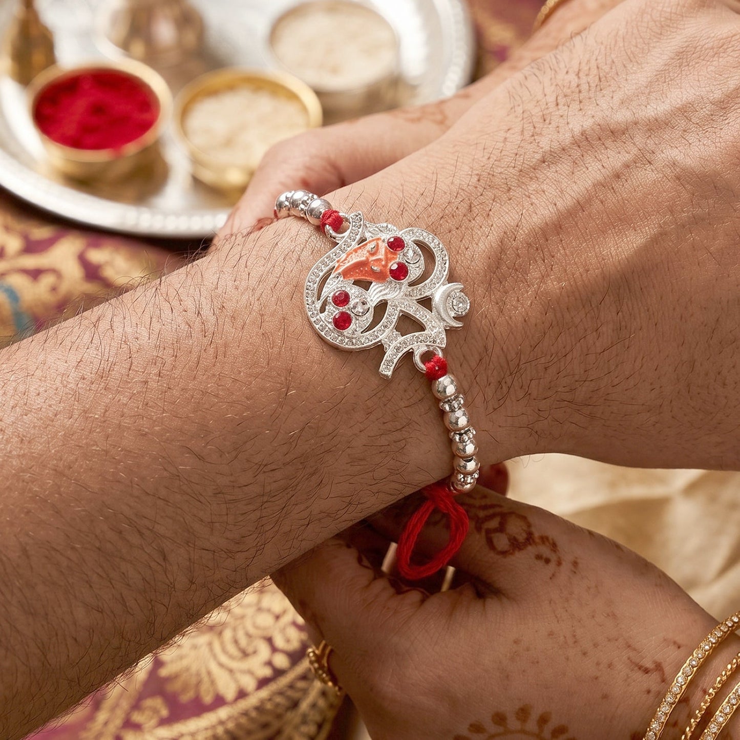 Festive Silver Om Ganesh Rakhi with decorative beads