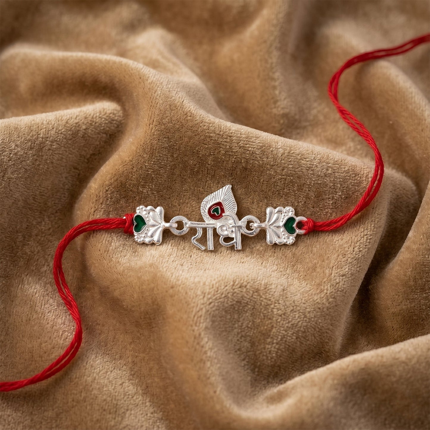 Side view of Silver Radhe Morpich Rakhi showcasing red thread