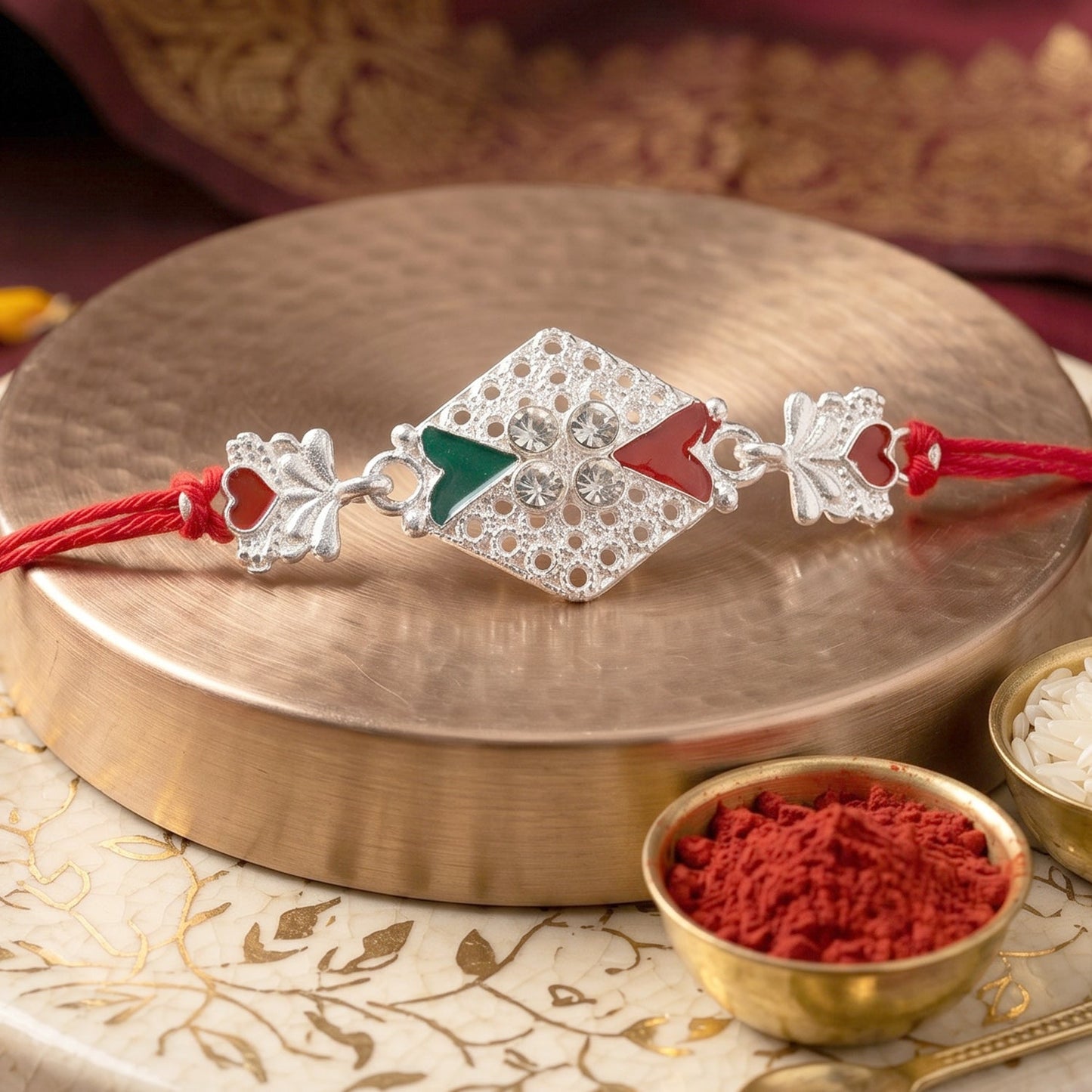 Close-up of silver elephant charm with decorative stones on rakhi