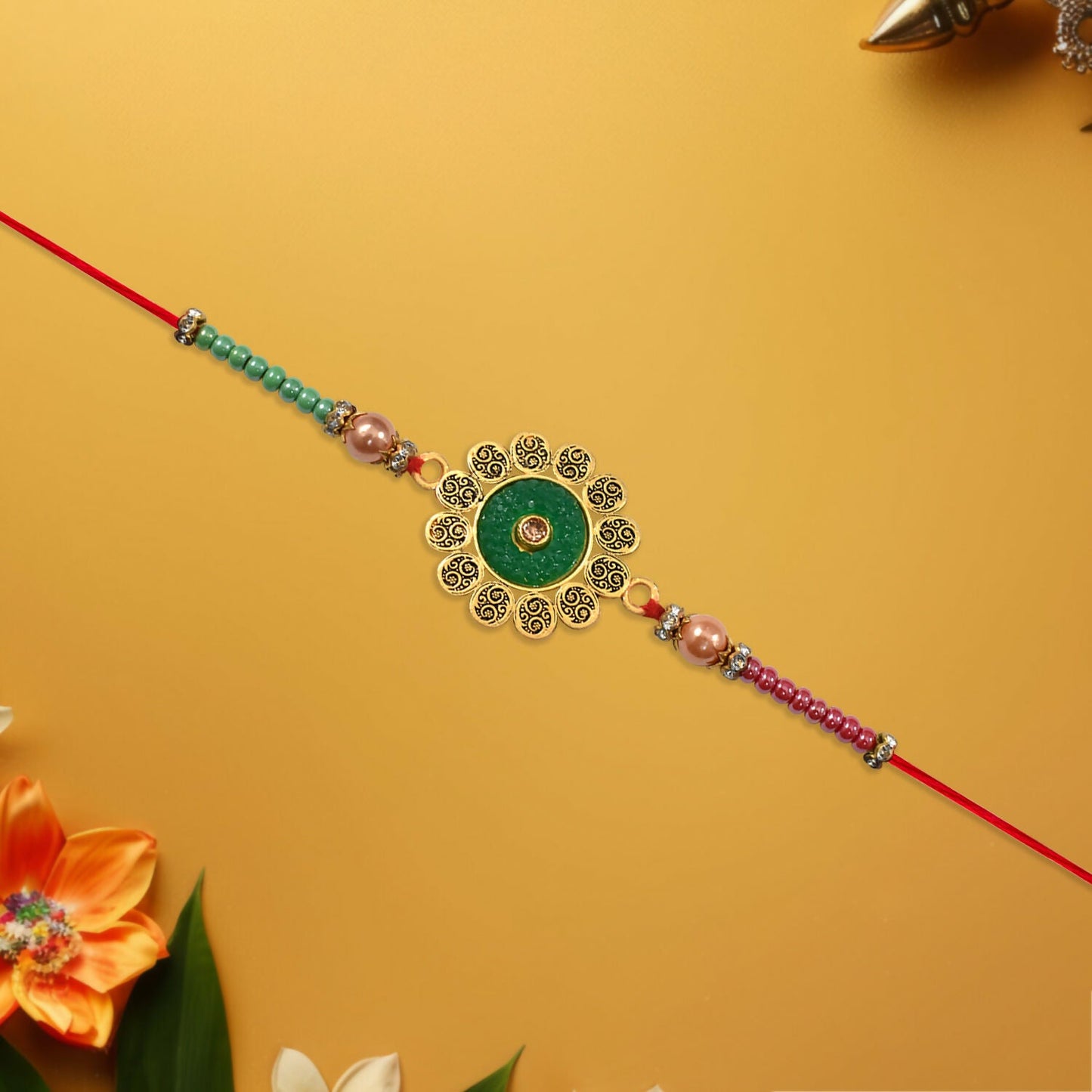 Close-up of floral Rakhi highlighting green centerpiece and colorful beads detail