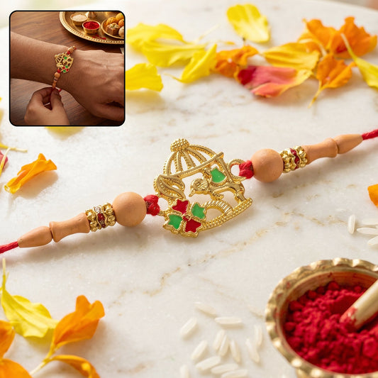 Golden bow and arrow Rakhi with red thread and decorative beads