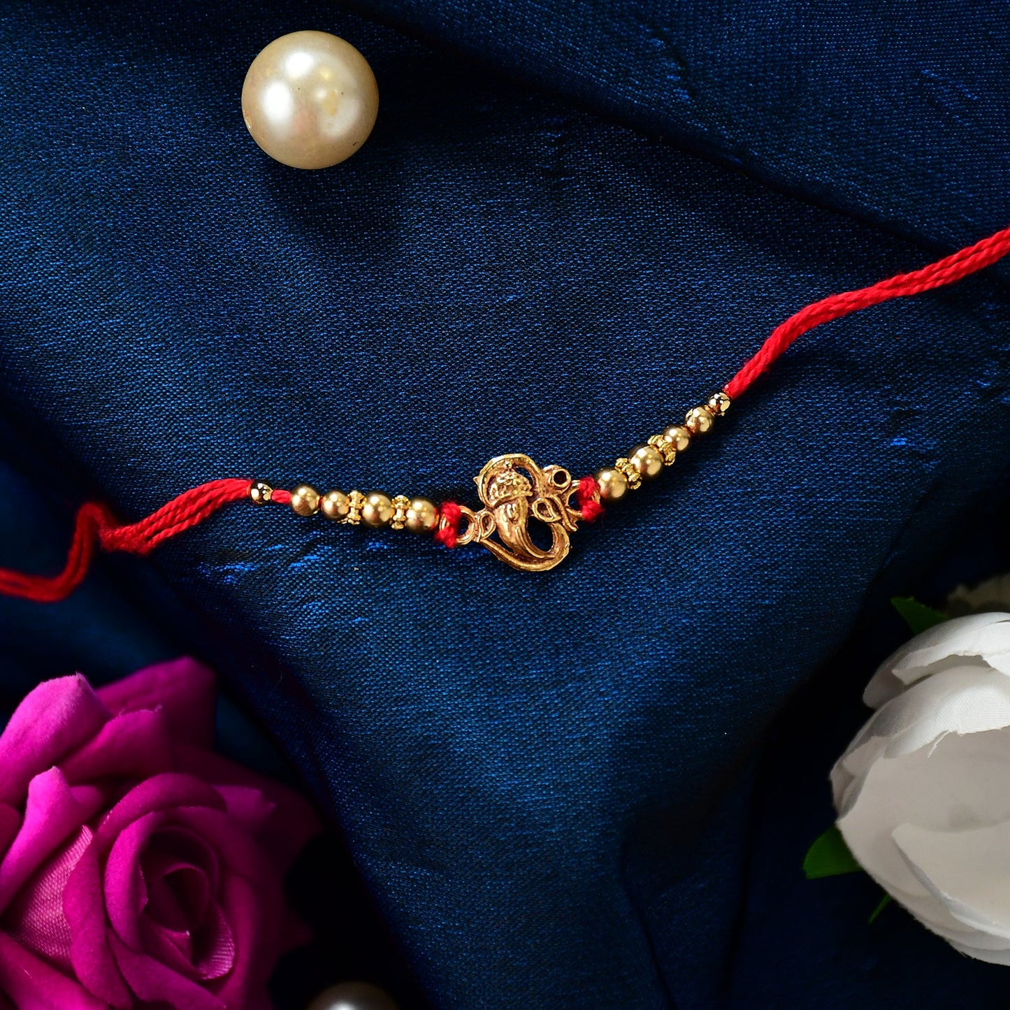Elegant Ganesha Rakhi displayed on a traditional thali, ready for rituals.