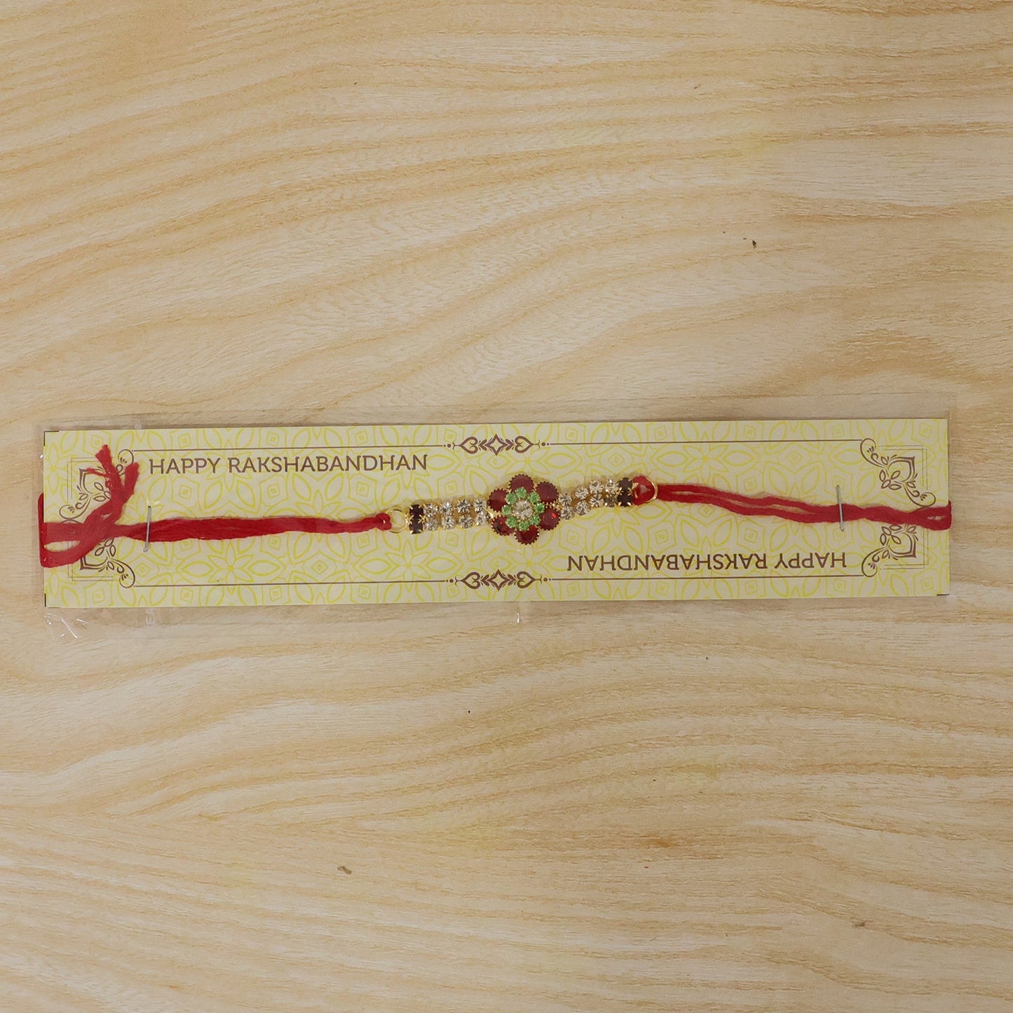 Lightweight red floral kundan rakhi with pearl ends for brothers