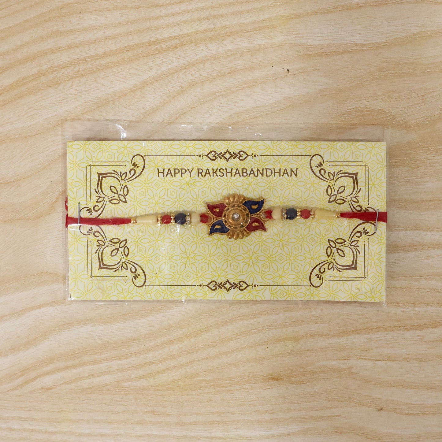 Stylish Gold Sunburst Rakhi with central motif and comfortable thread.