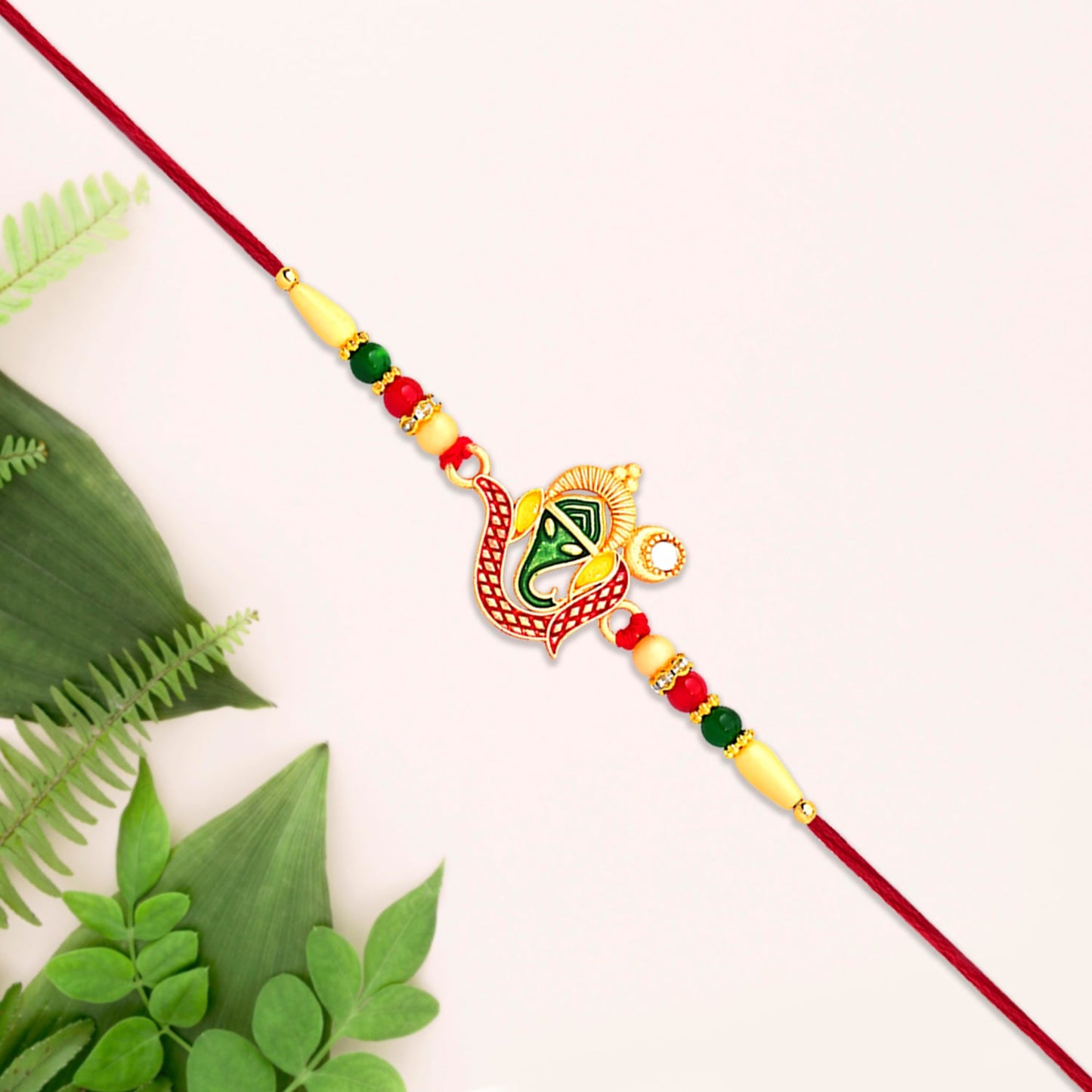 Side view highlighting beadwork and fine craftsmanship of Ganpati Rakhi