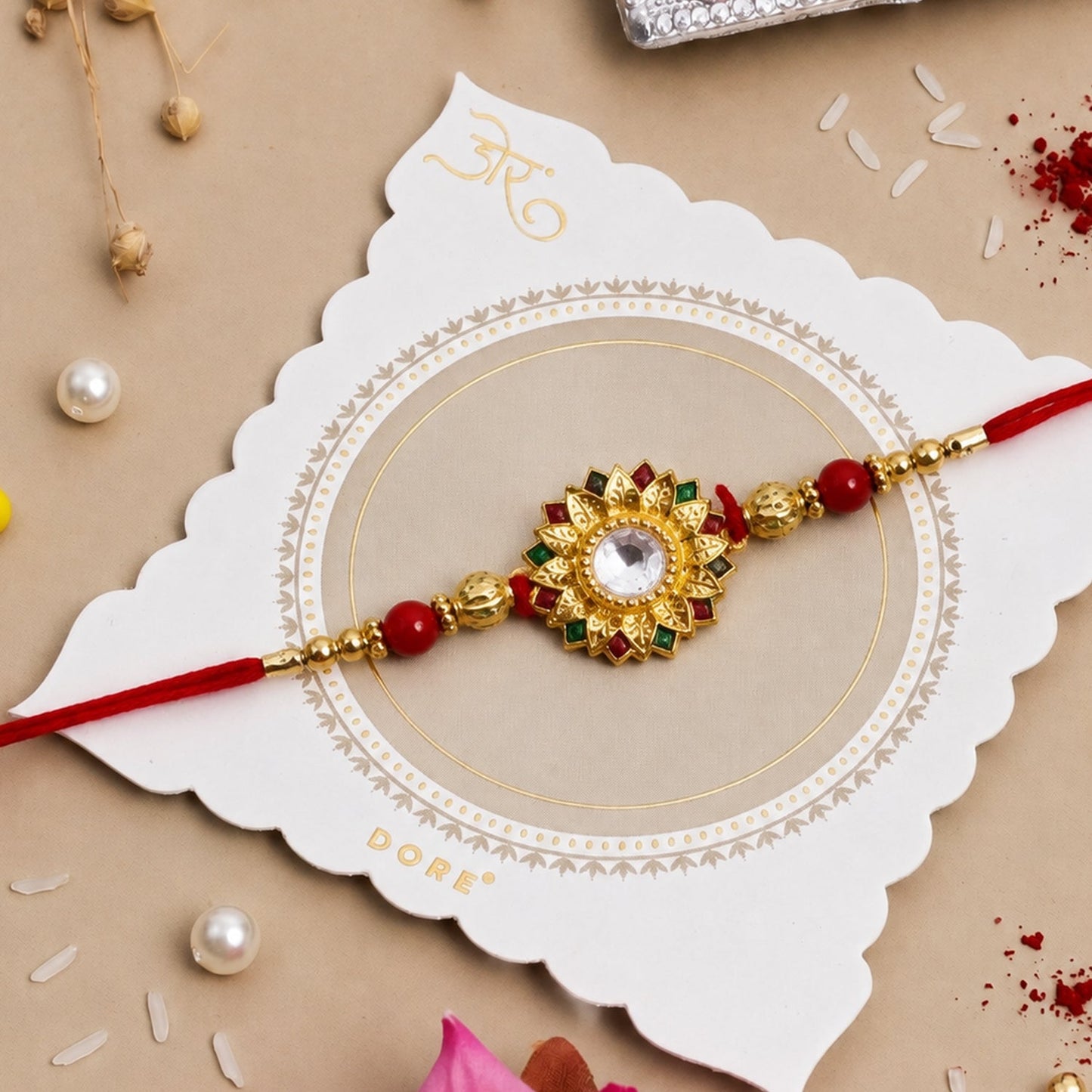 Traditional Rakhi with intricate design on red thread for Raksha Bandhan