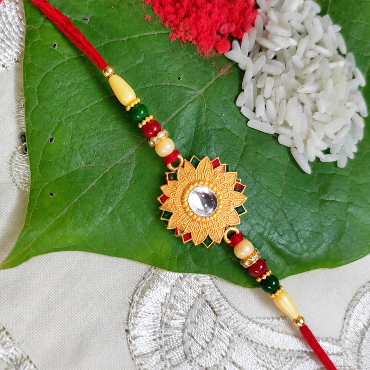 Floral mirror Rakhi with intricate design, perfect for Raksha Bandhan celebrations