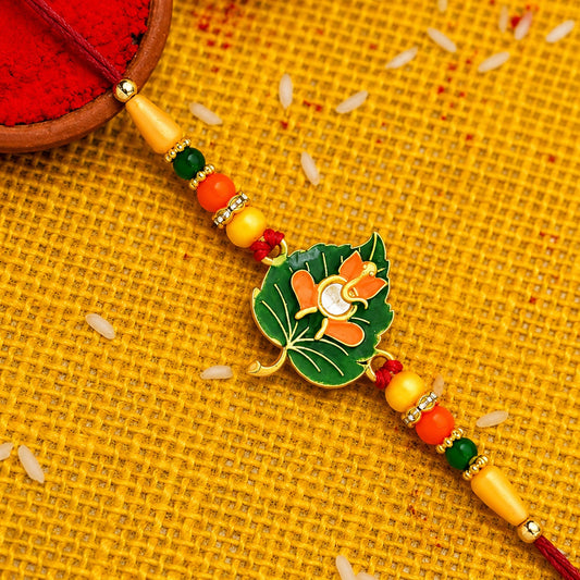 Green Tulsi leaf Rakhi with orange enamel flower on beaded thread