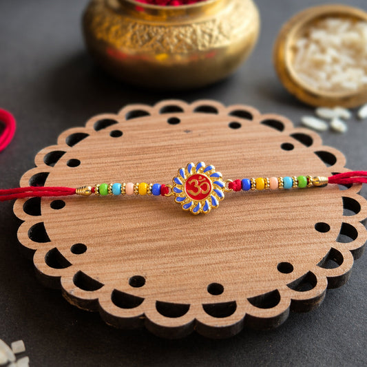 Traditional OM symbol Rakhi with colorful beads and red thread