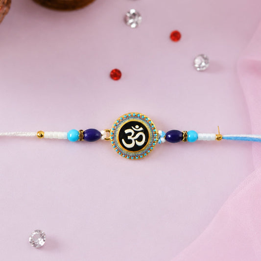 Close-up of Om Designer Rakhi with blue beads and elegant design