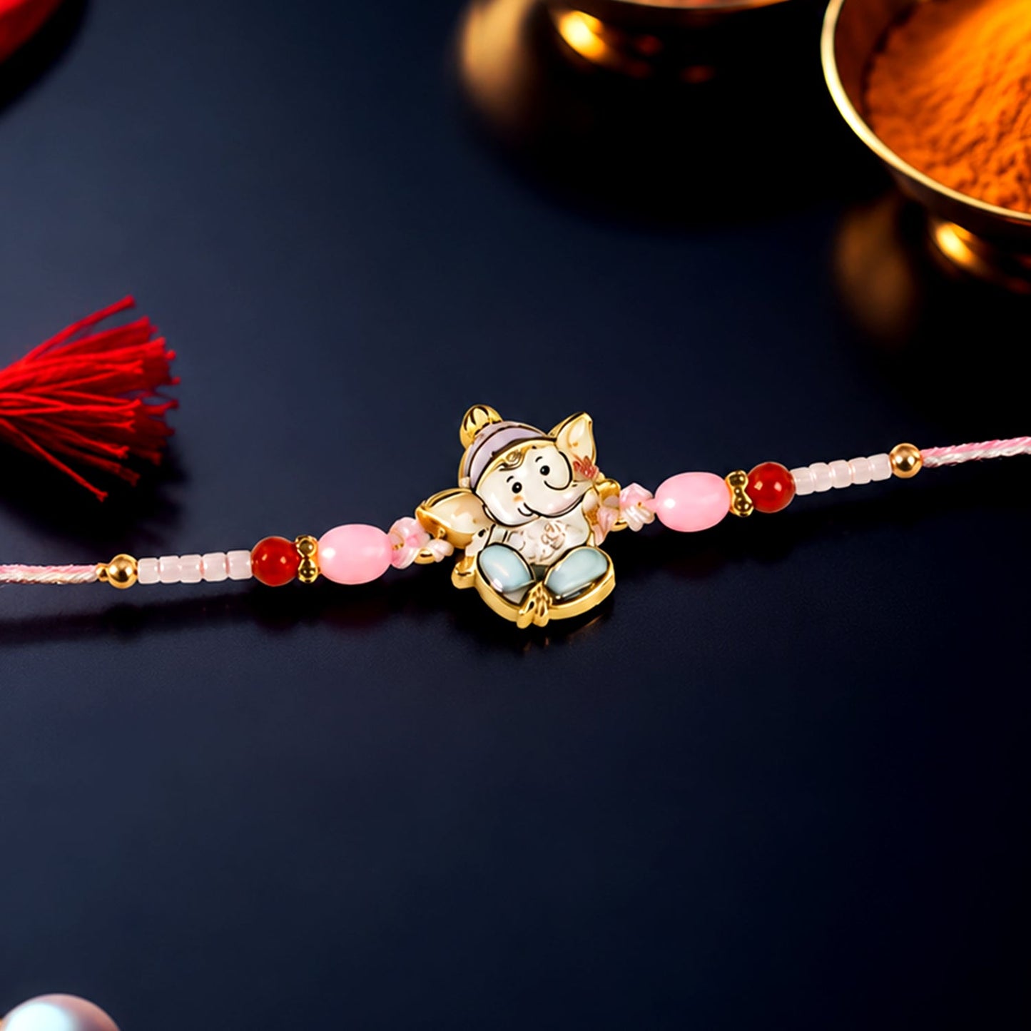 Ganesha designer Rakhi with pink and red beads showcasing festive appeal
