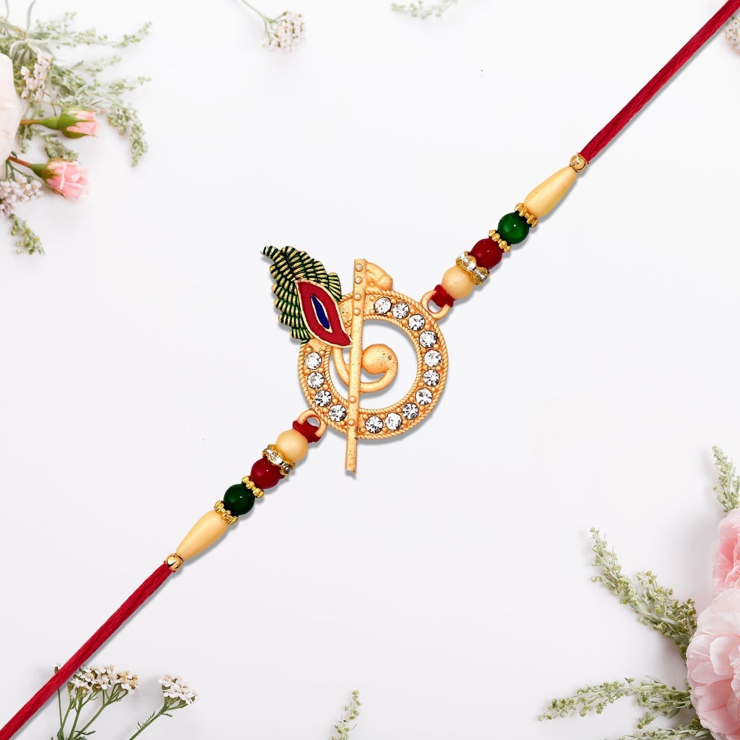Side view of the Krishna Flute Rakhi, displaying its elegant thread and central design.