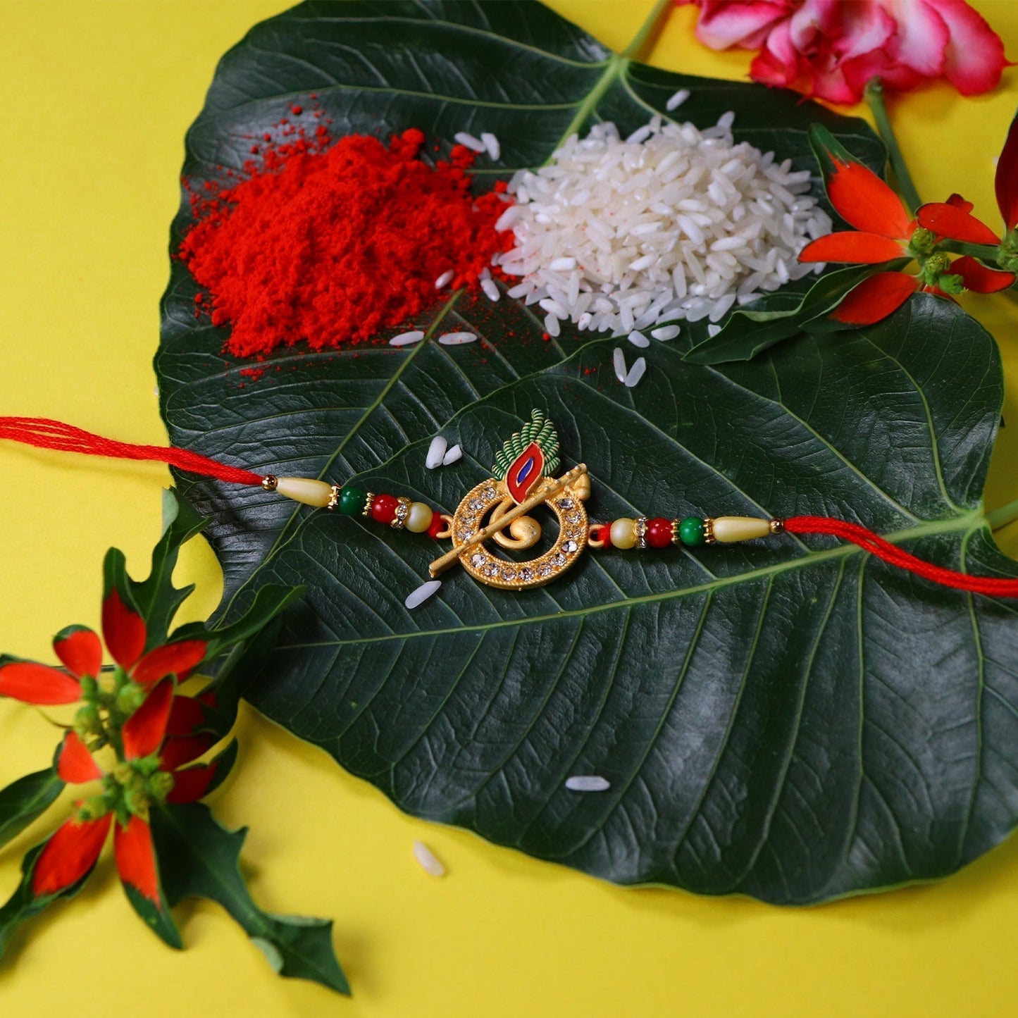 Detailed view of the Krishna Flute Rakhi, highlighting the shimmering stones and peacock feather.