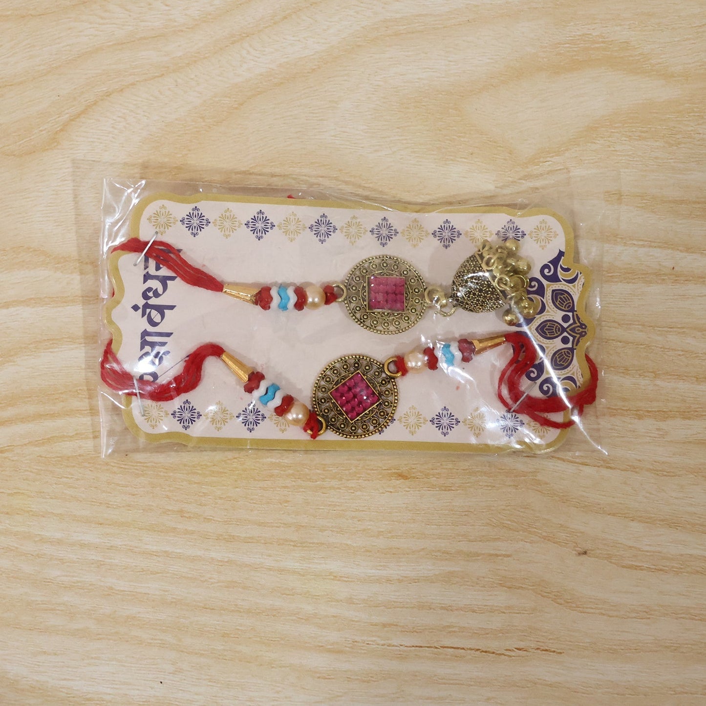 Close-up of golden latkan on Meenakari Bead Bhabhi Rakhi
