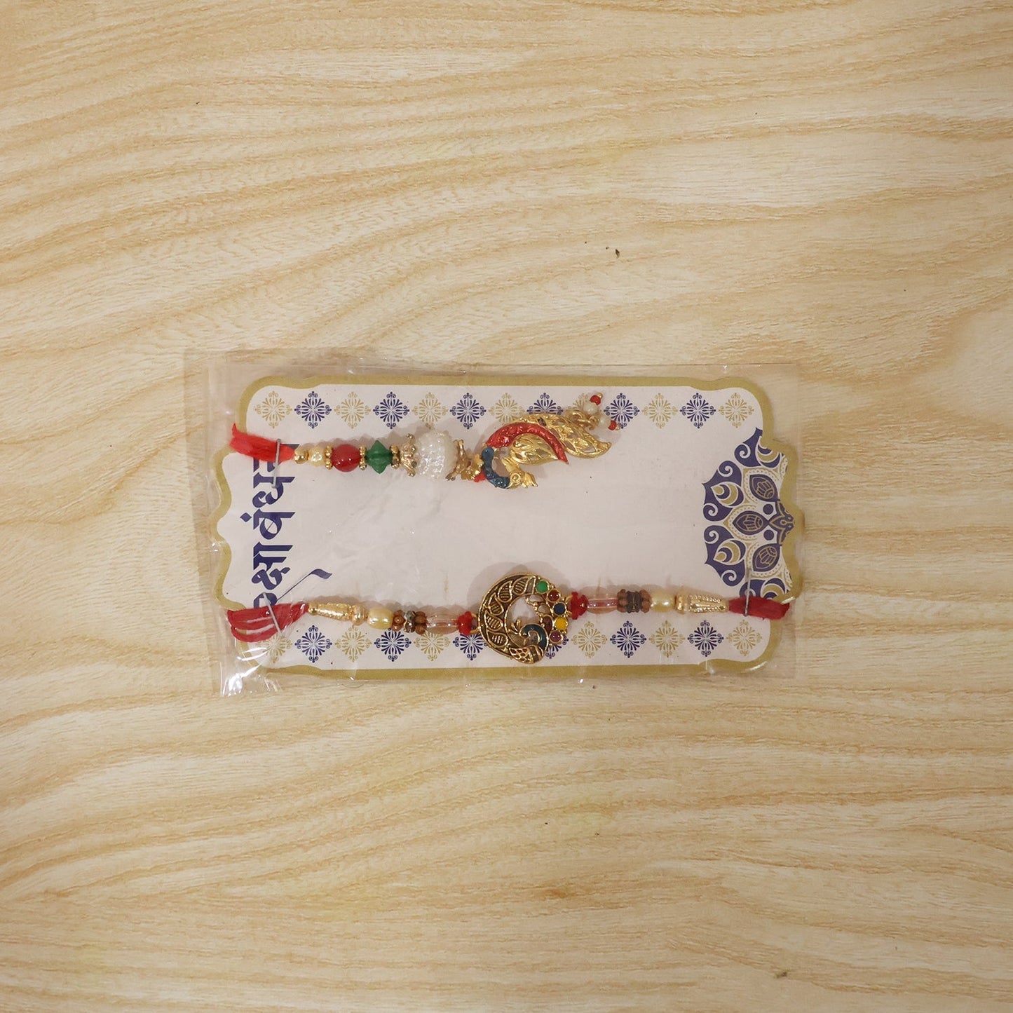 Full layout of Peacock Pendant Bhabhi Rakhi with red green beads