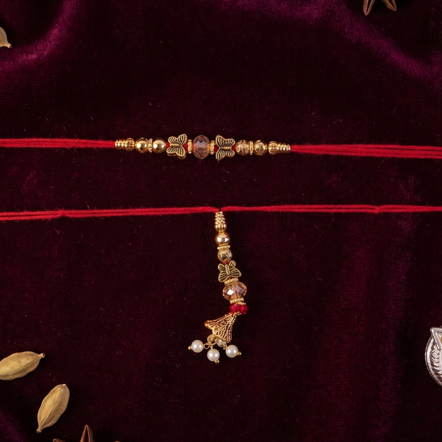 Close-up of Sleek Stone Bhabhi Rakhi with gold latkan on a white background
