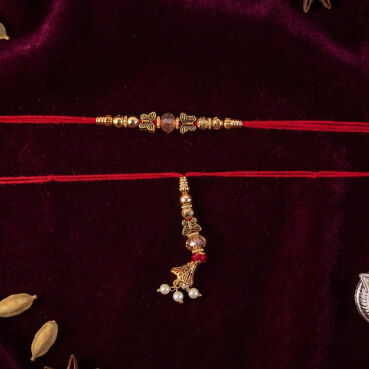 Close-up of Sleek Stone Bhabhi Rakhi with gold latkan on a white background