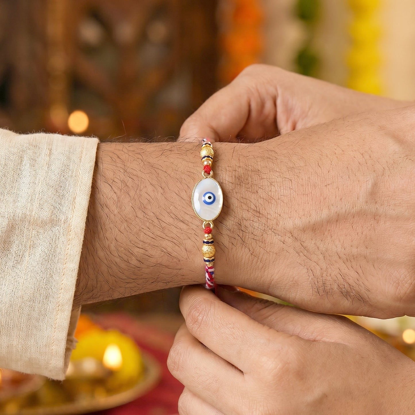 Close-up of Evil Eye Bhabhi Rakhi detailing the white beads and protective evil eye symbol