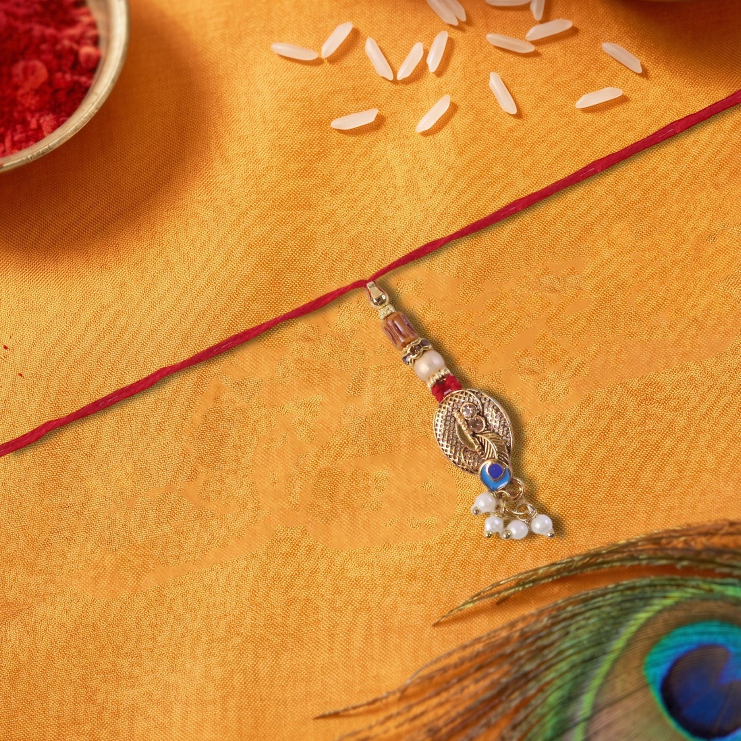 Close-up of Blue Stone Bhabhi Rakhi with pearl cluster latkan