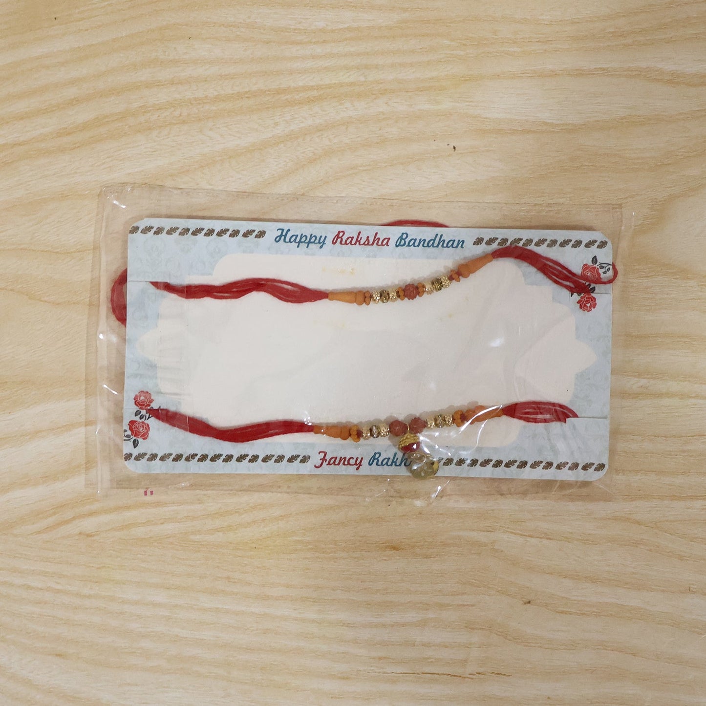 Elegant Rudraksha Bead Bhabhi Rakhi with Om Charm packaging