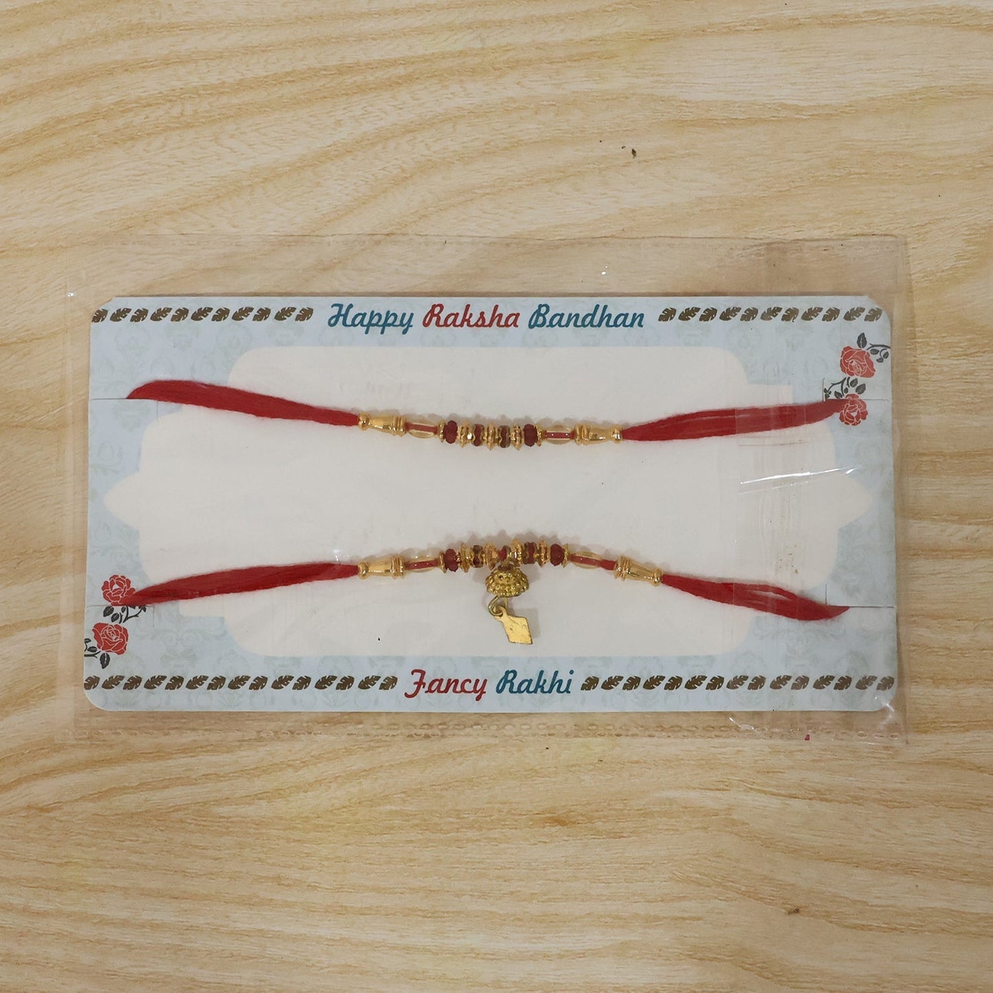Full display of golden beaded Bhabhi Rakhi on white background