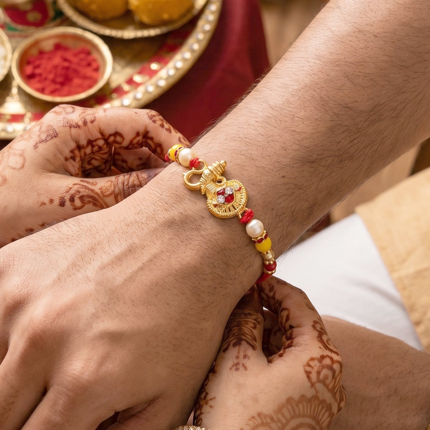 Top view of designer rakhi featuring unique golden Ganesha
