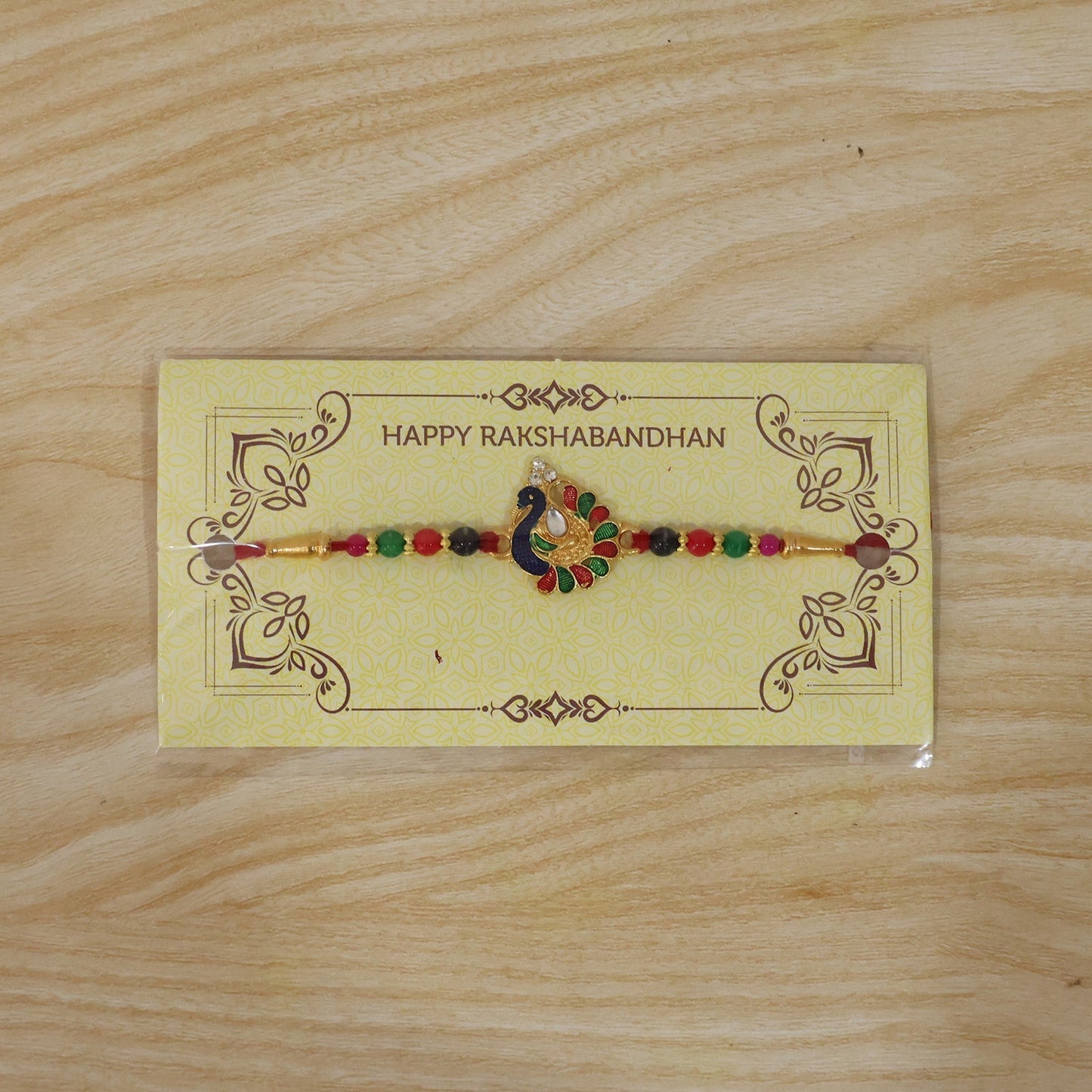 Festive Rakhi with peacock design and multicolor beads