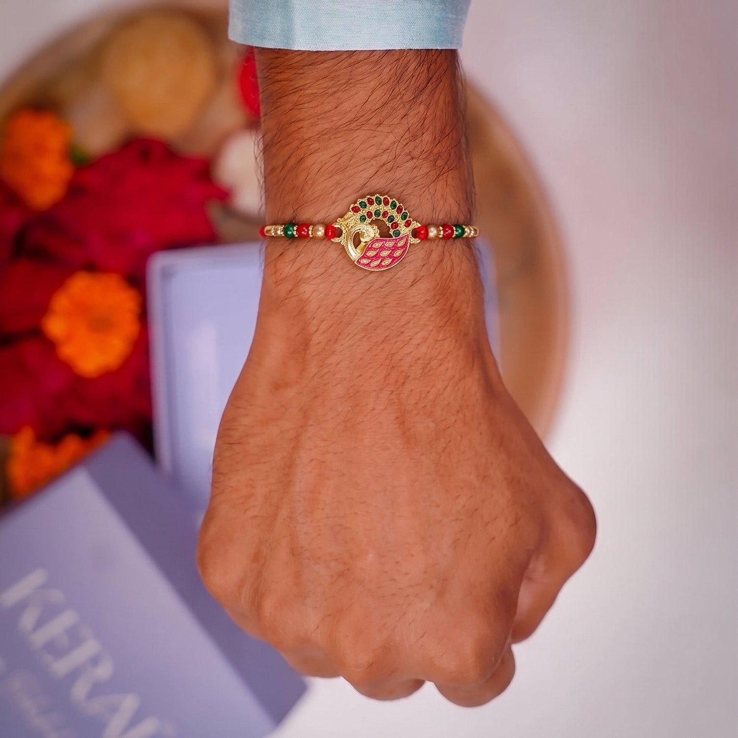 Close-up of decorative centerpiece on Pink Peacock Rakhi