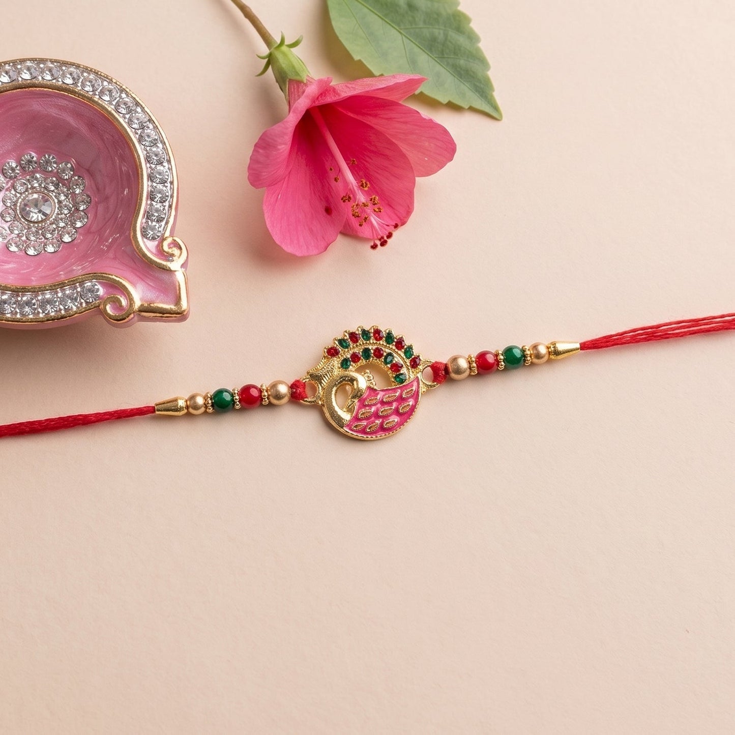 Full view of Pink Peacock Rakhi with beads and soft thread