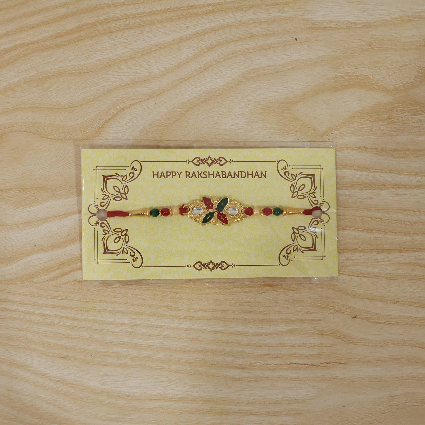 Close-up of floral leaf Rakhi showing colorful beads and intricate design