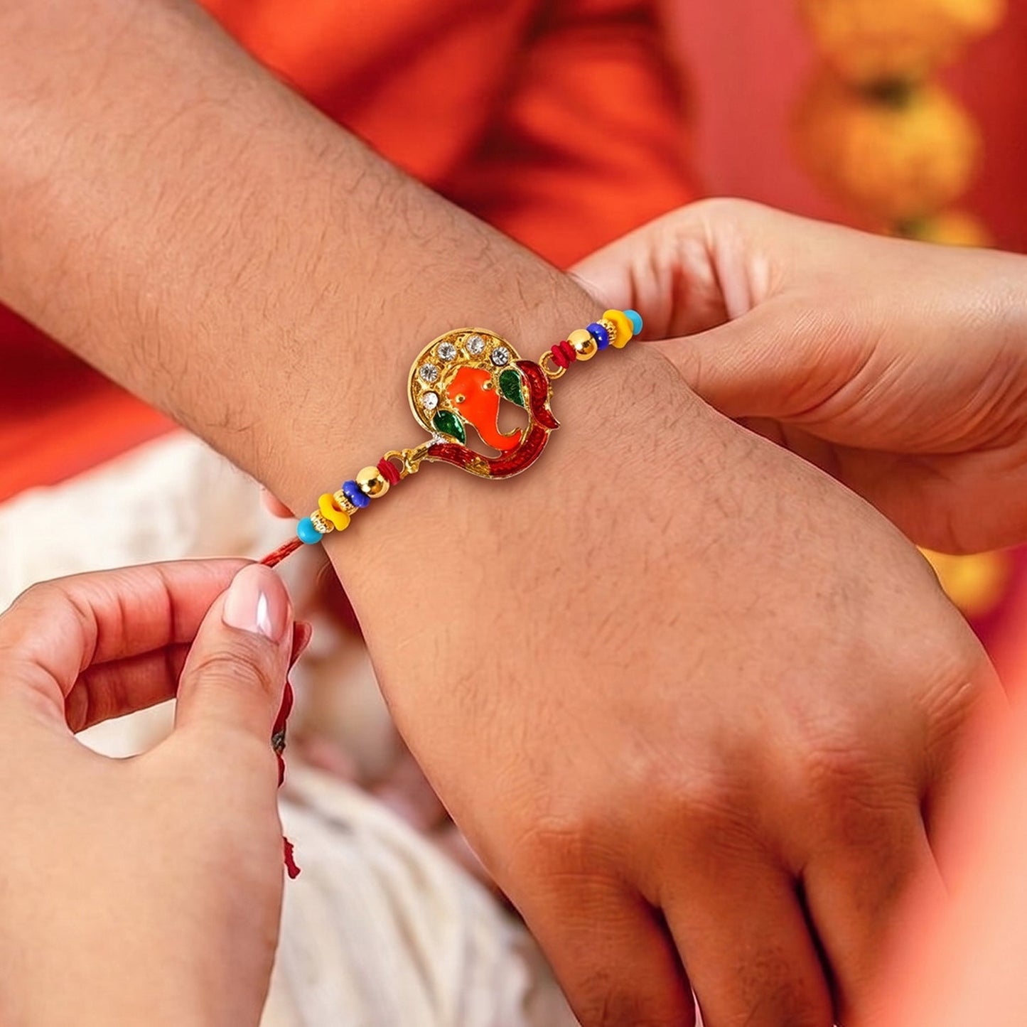 Close-up of Ganesh centerpiece on Rakhi with decorative beads