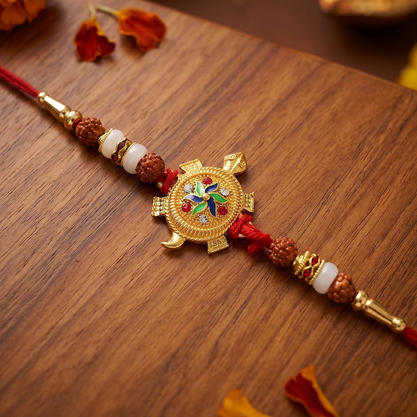 Close-up of turtle centerpiece and Rudraksha beads on Rakhi