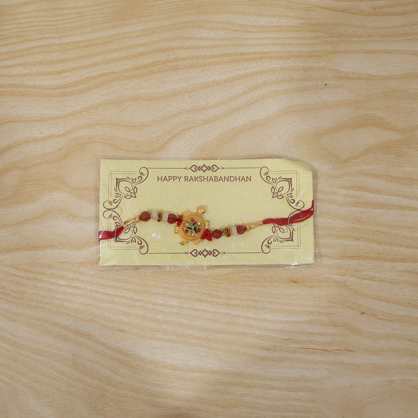 Close-up of turtle centerpiece and Rudraksha beads on Rakhi