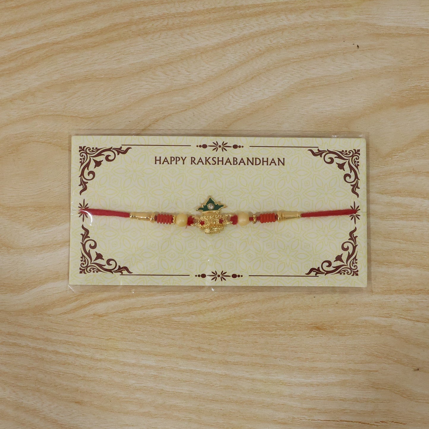 Kalash Rakhi laying flat showcasing details