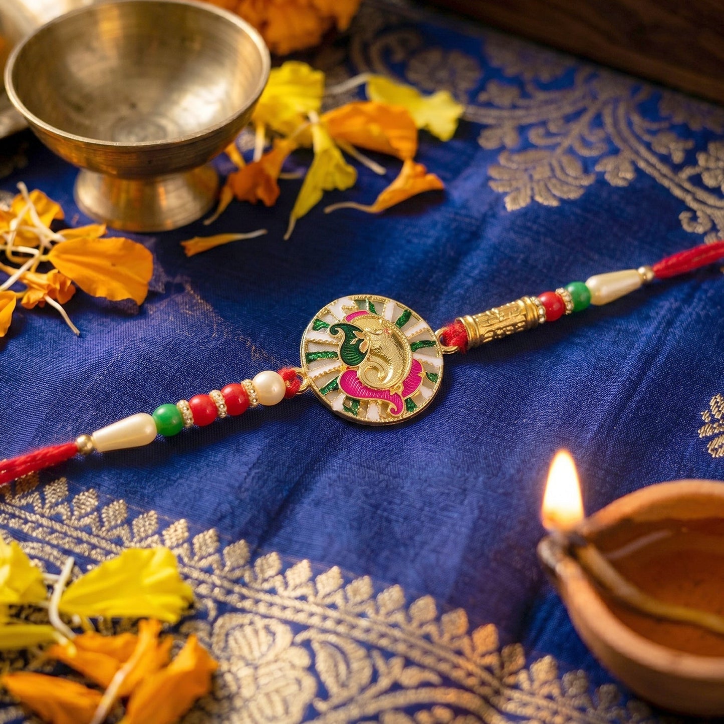 Close-up of Ganesh motif with decorative beads on Rakhi