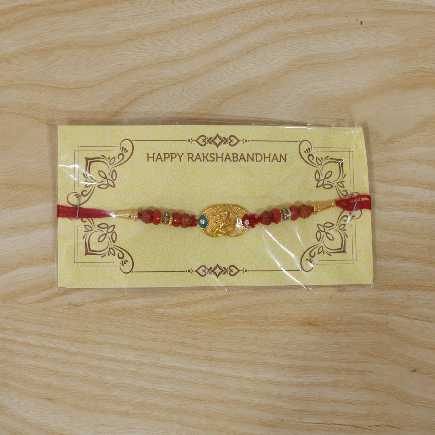 Full view of Ganesh Design Rakhi showing bead and thread details