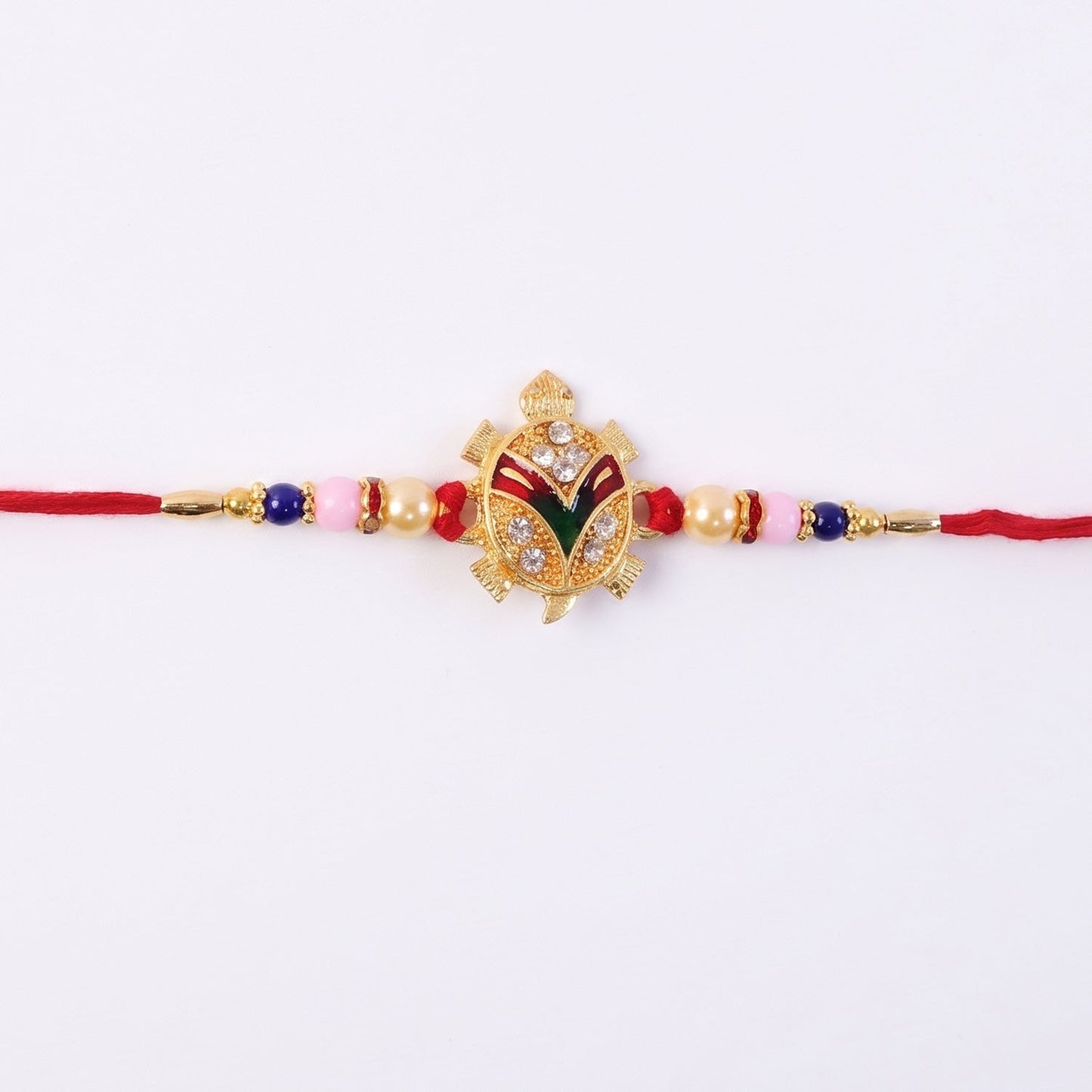Elegant golden turtle design Rakhi with pearl accents