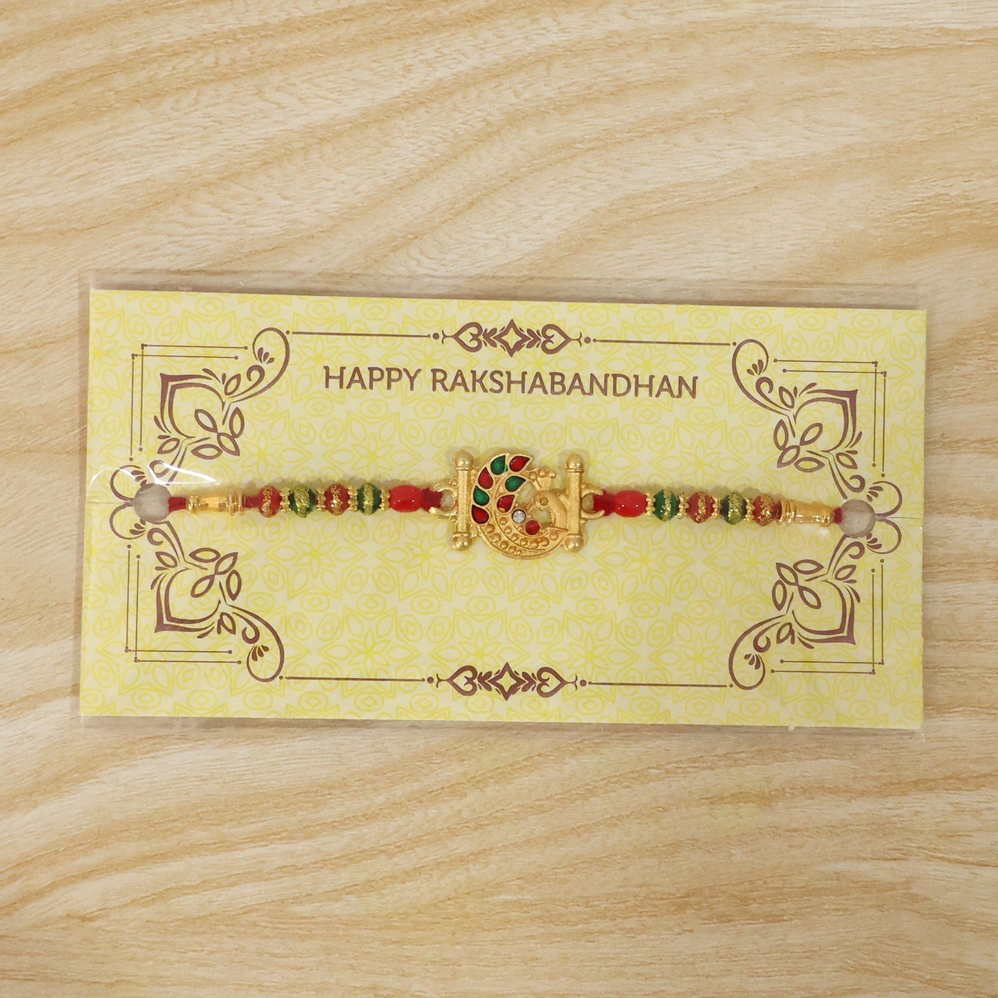 Complete golden peacock Rakhi with bright colorful beads
