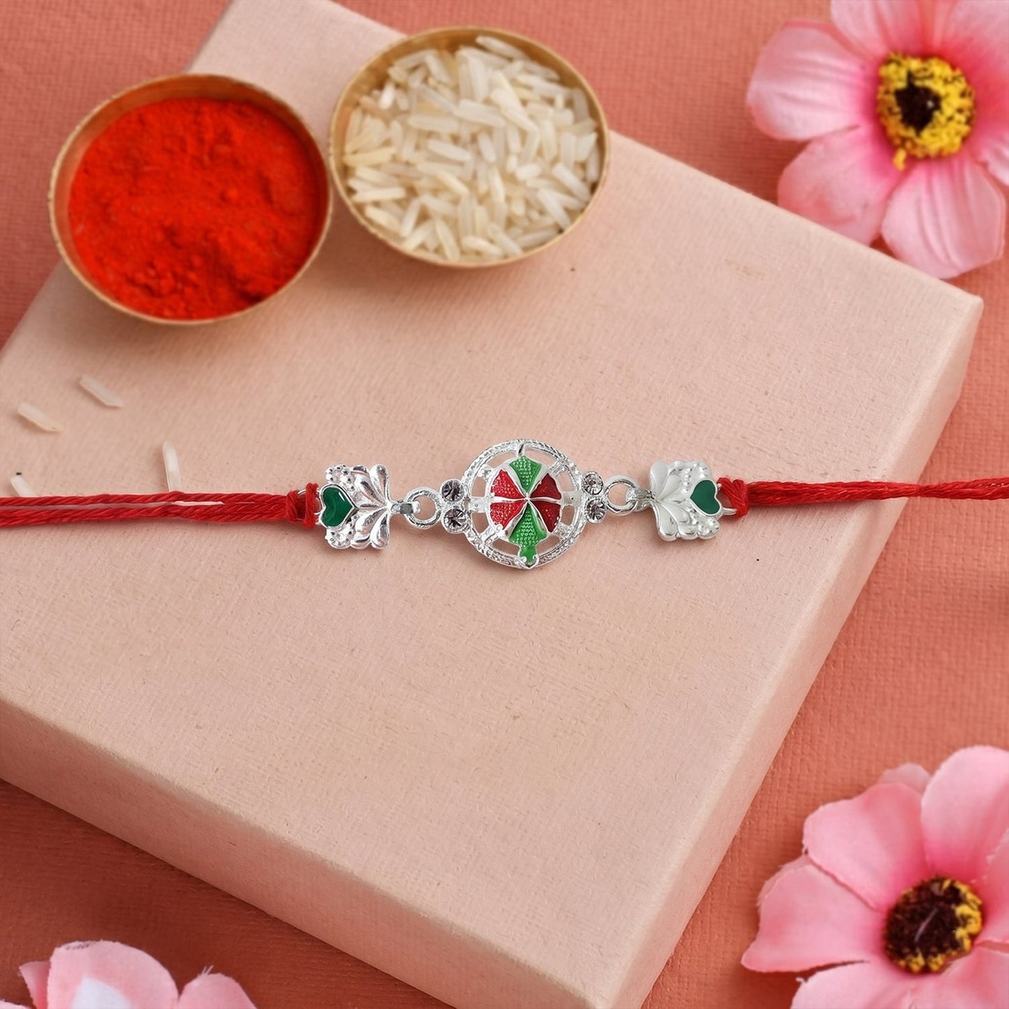 Close-up of silver floral Rakhi centerpiece with beads